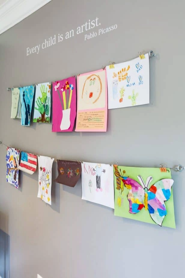 A closer look at how we display kids art at home, on the wall in the playroom, using wire and binder clips.