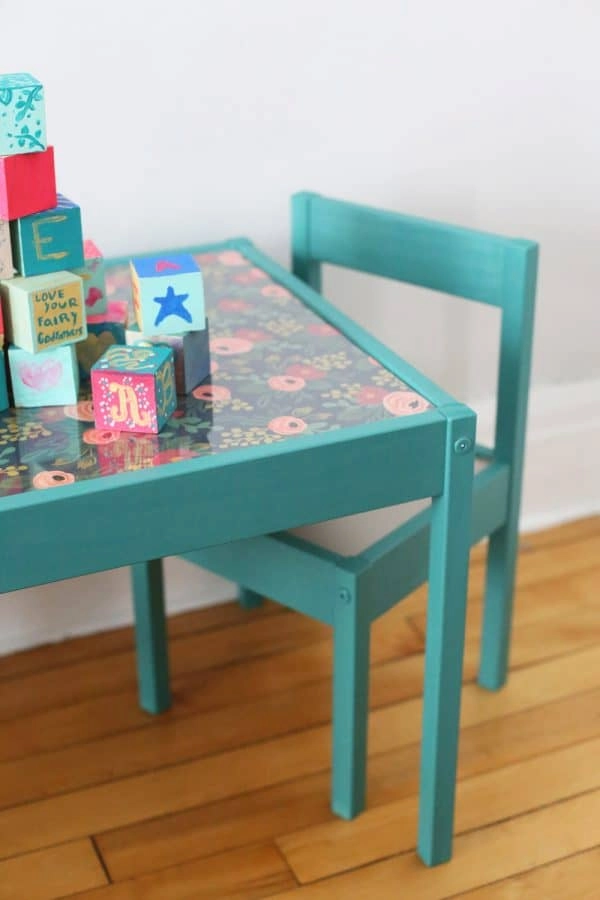 This kid-sized IKEA table and chair set was updated into a fun play table with some teal blue paint and floral wrapping paper.