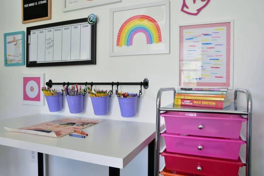A closer look at the rainbow storage rack and wall-mounted storage for pencils and markers at the small space homework station in our daughter's room.