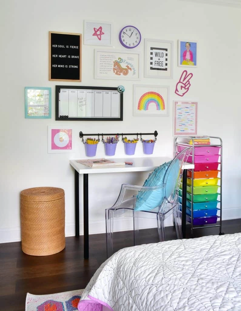 A closer look at the small space homework station with a desk from IKEA, chair, colorful storage cart, and gallery wall.