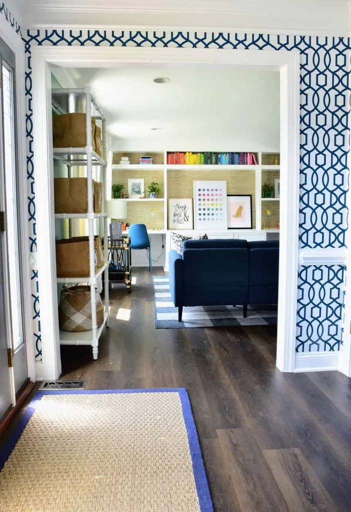A look at the updated kids playroom through a doorway, looking at the build-in bookshelf and desk against the far wall.